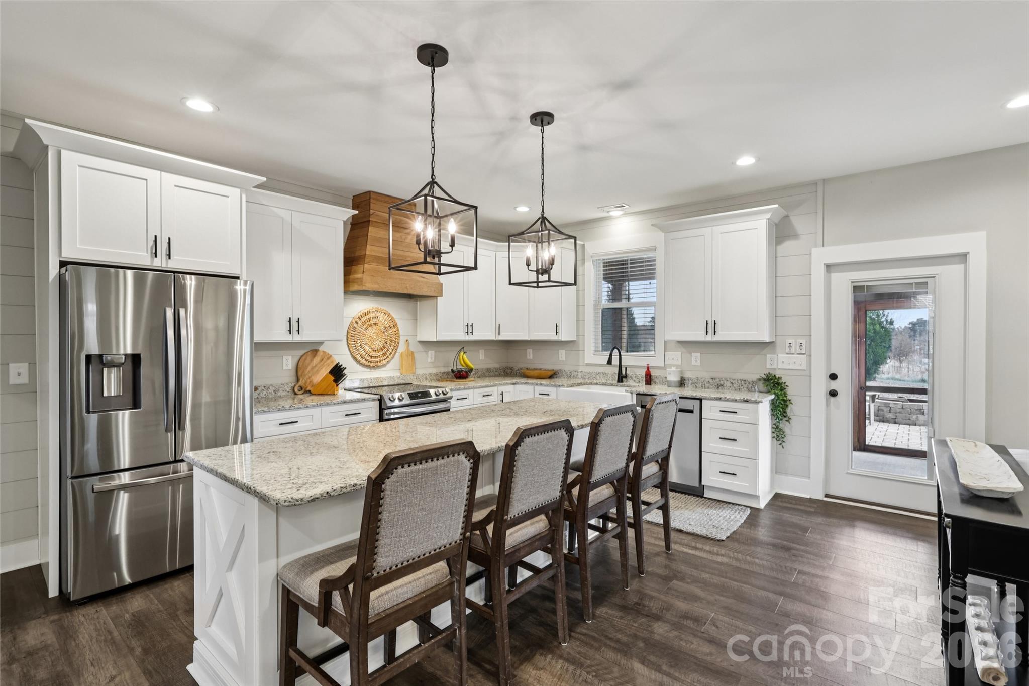 2807 Noritake Trail Albemarle, NC 28001 - Photo 15 of 45 a kitchen with stainless steel appliances granite countertop a dining table chairs stove refrigerator and cabinets