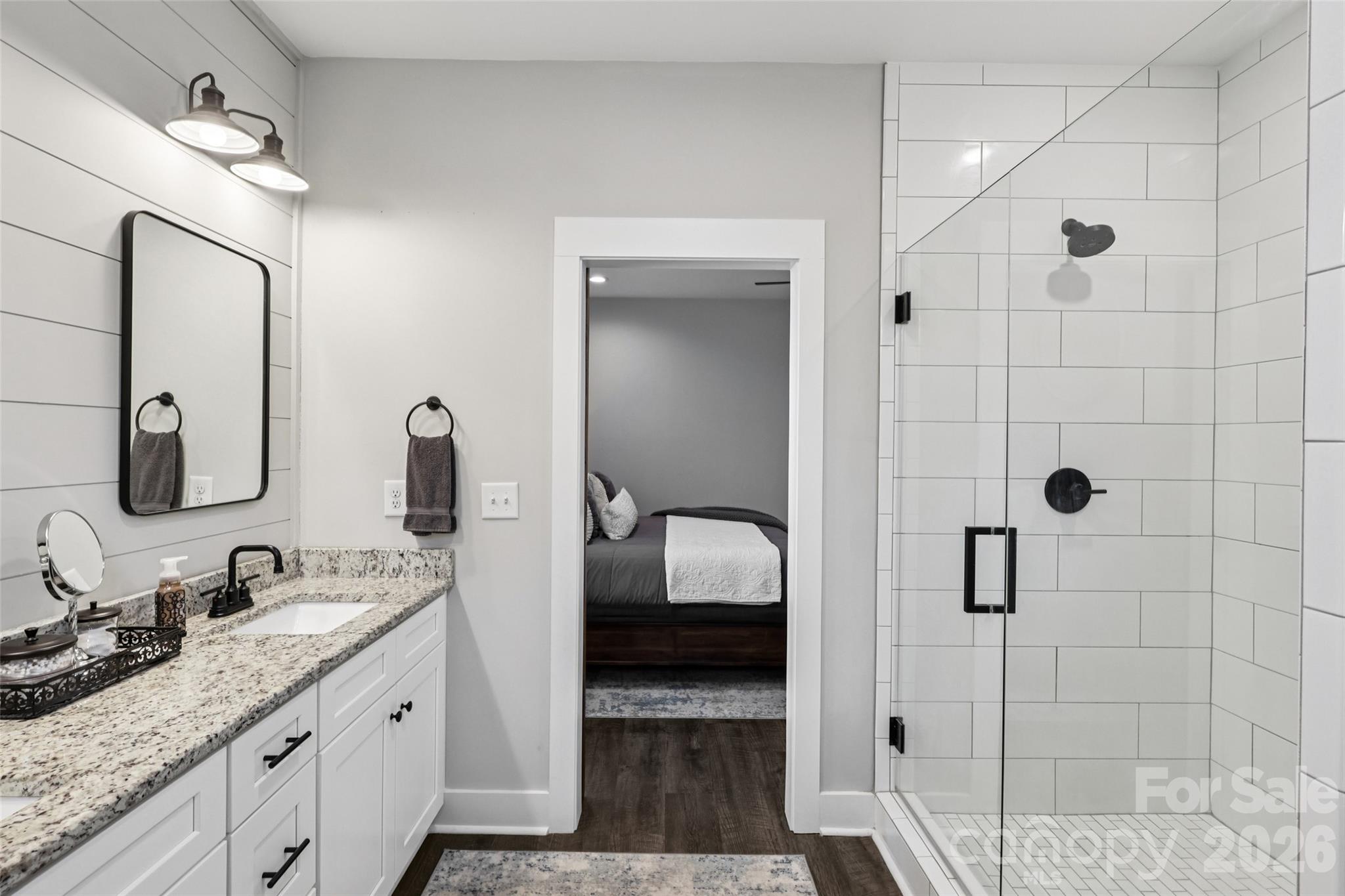 2807 Noritake Trail Albemarle, NC 28001 - Photo 28 of 45 a en suite bathroom with a granite countertop sink a mirror and shower