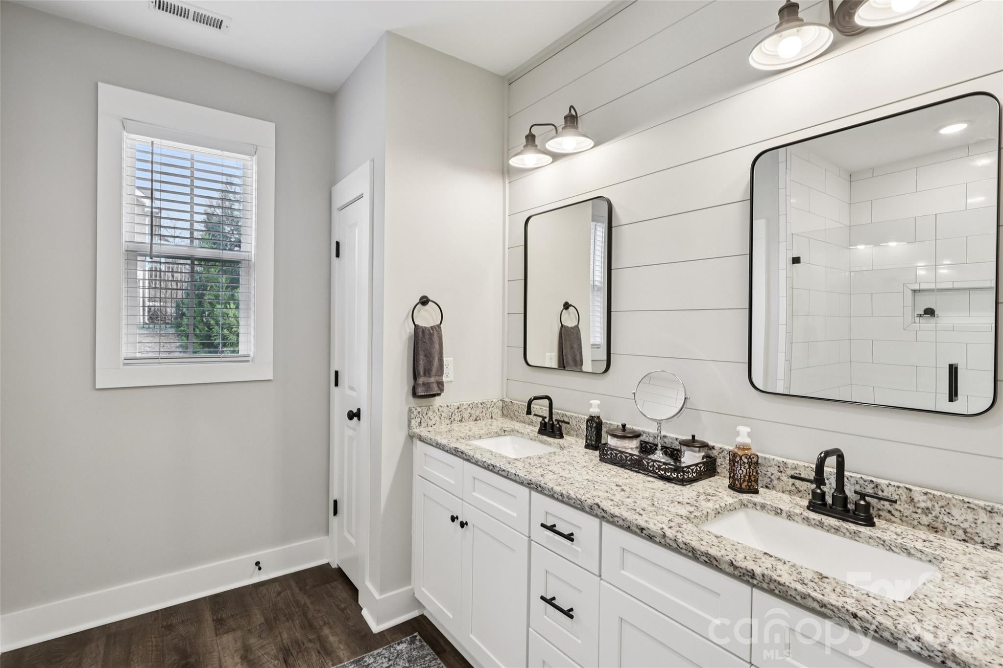 2807 Noritake Trail Albemarle, NC 28001 - Photo 30 of 45 a bathroom with double vanity sink a mirror and a shower