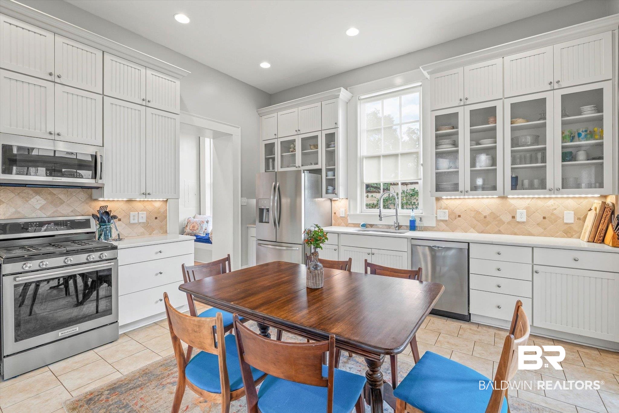 259 North Jackson Street Mobile, AL 36603 - Photo 12 of 42 Kitchen with stainless steel appliances, glass insert cabinets, white cabinetry, recessed lighting, and decorative backsplash