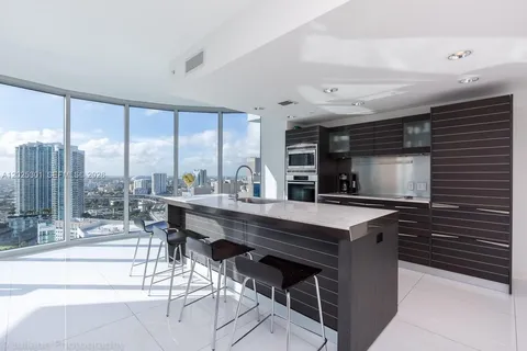 a kitchen with a sink and stainless steel appliances