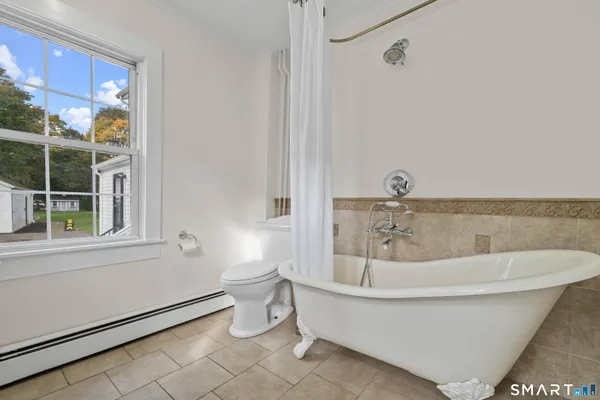 a white bath tub sitting next to a white toilet