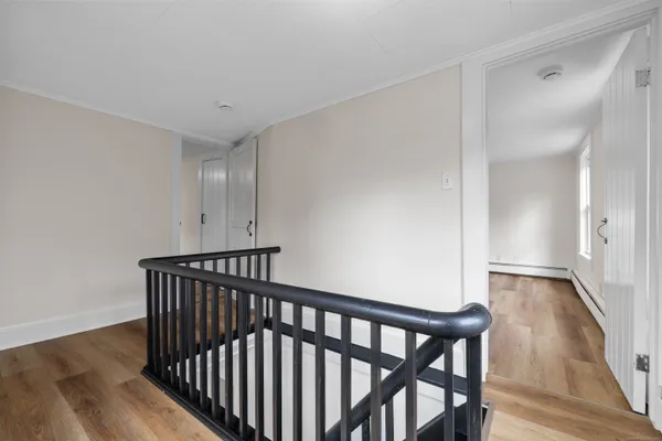 a view of hallway with wooden floor