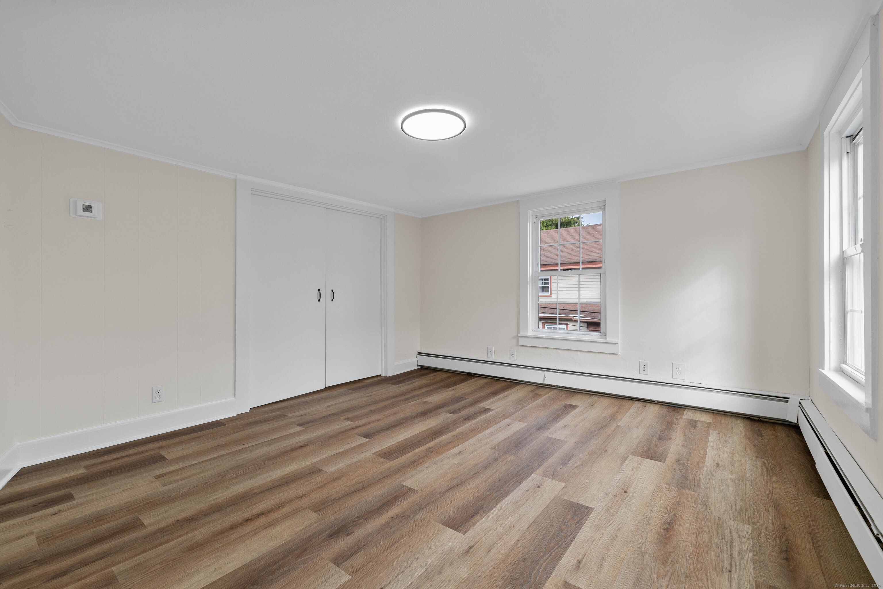 82 State Street Guilford, CT 06437 - Photo 15 of 40 a view of an empty room with wooden floor and a window