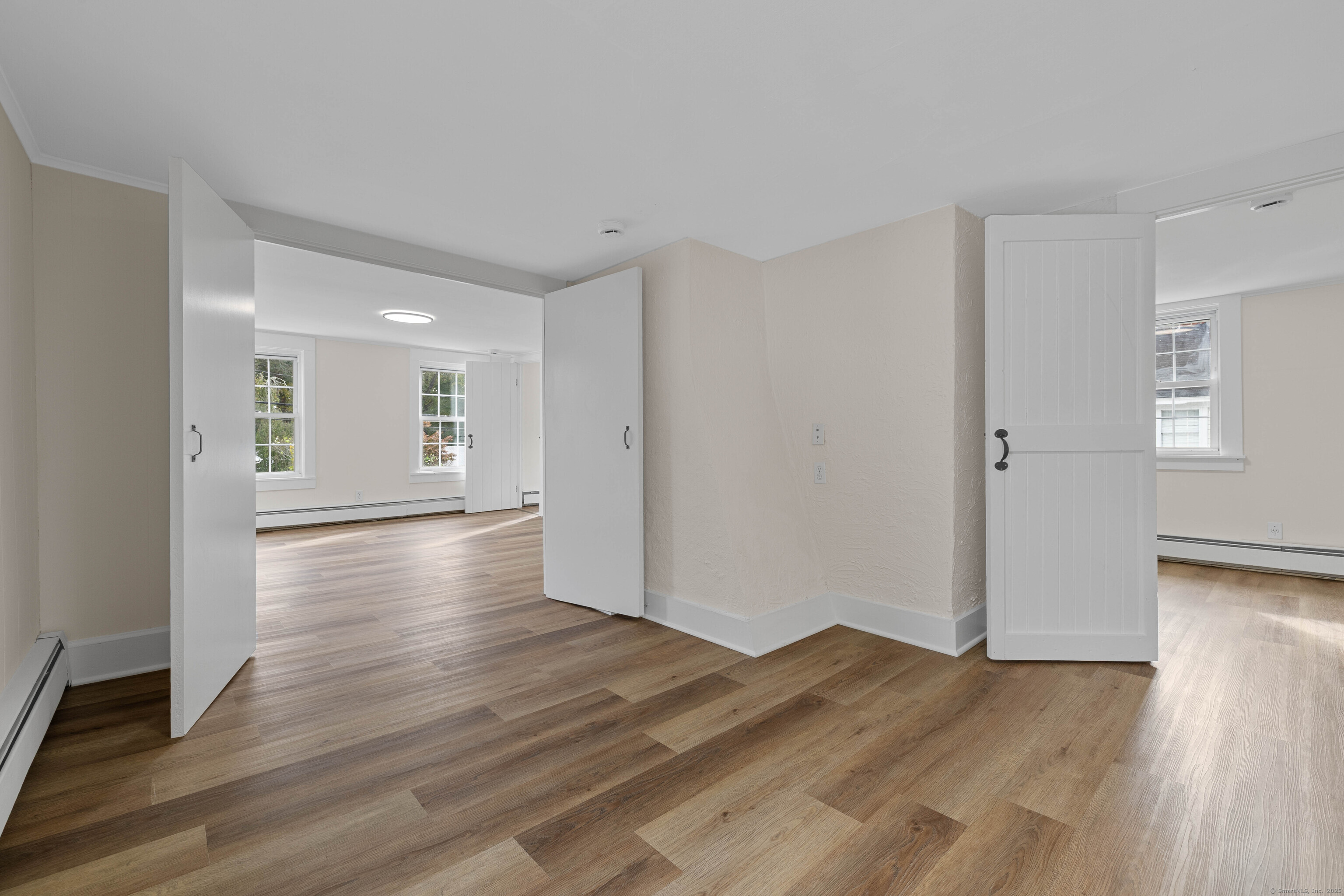 82 State Street Guilford, CT 06437 - Photo 16 of 40 an empty room with wooden floor & windows and bathroom