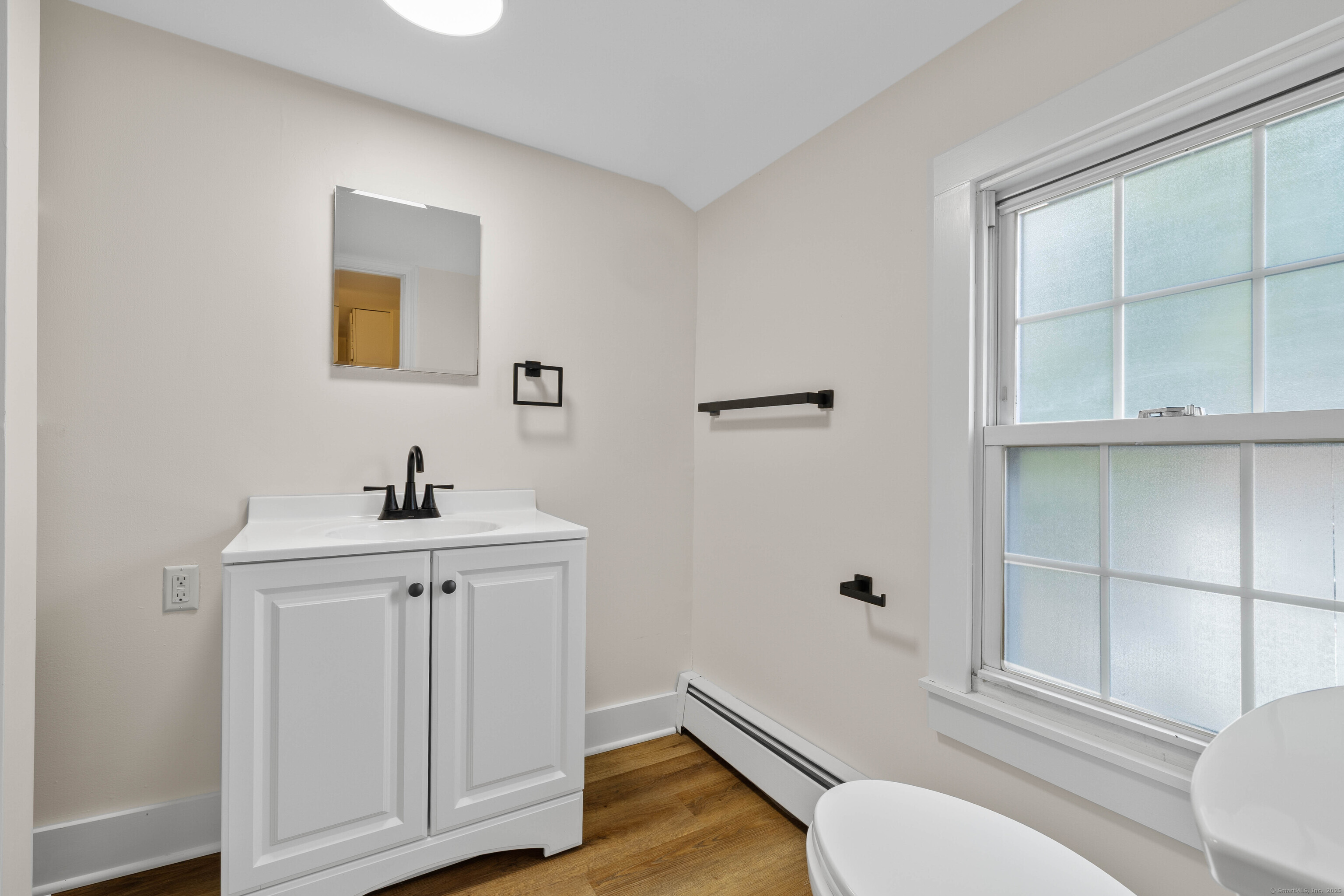 82 State Street Guilford, CT 06437 - Photo 18 of 40 a bathroom with a sink a toilet and shower