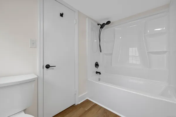 a bathroom with a bathtub a toilet and a shower