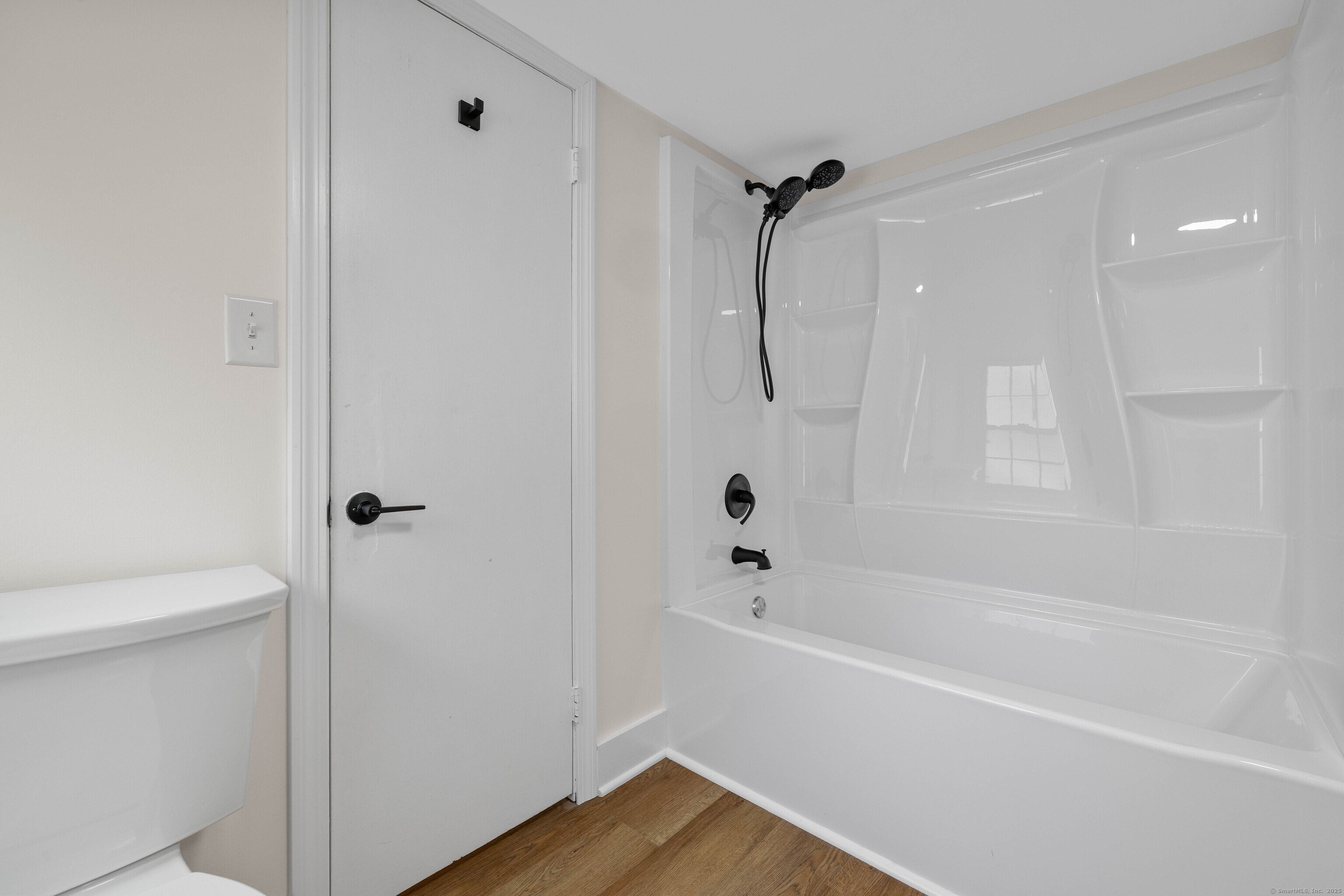 82 State Street Guilford, CT 06437 - Photo 19 of 40 a bathroom with a bathtub a toilet and a shower