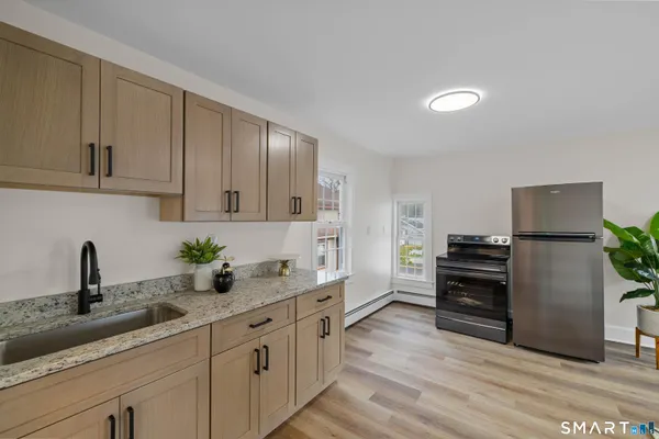 a view of a dining room with furniture and wooden floor
