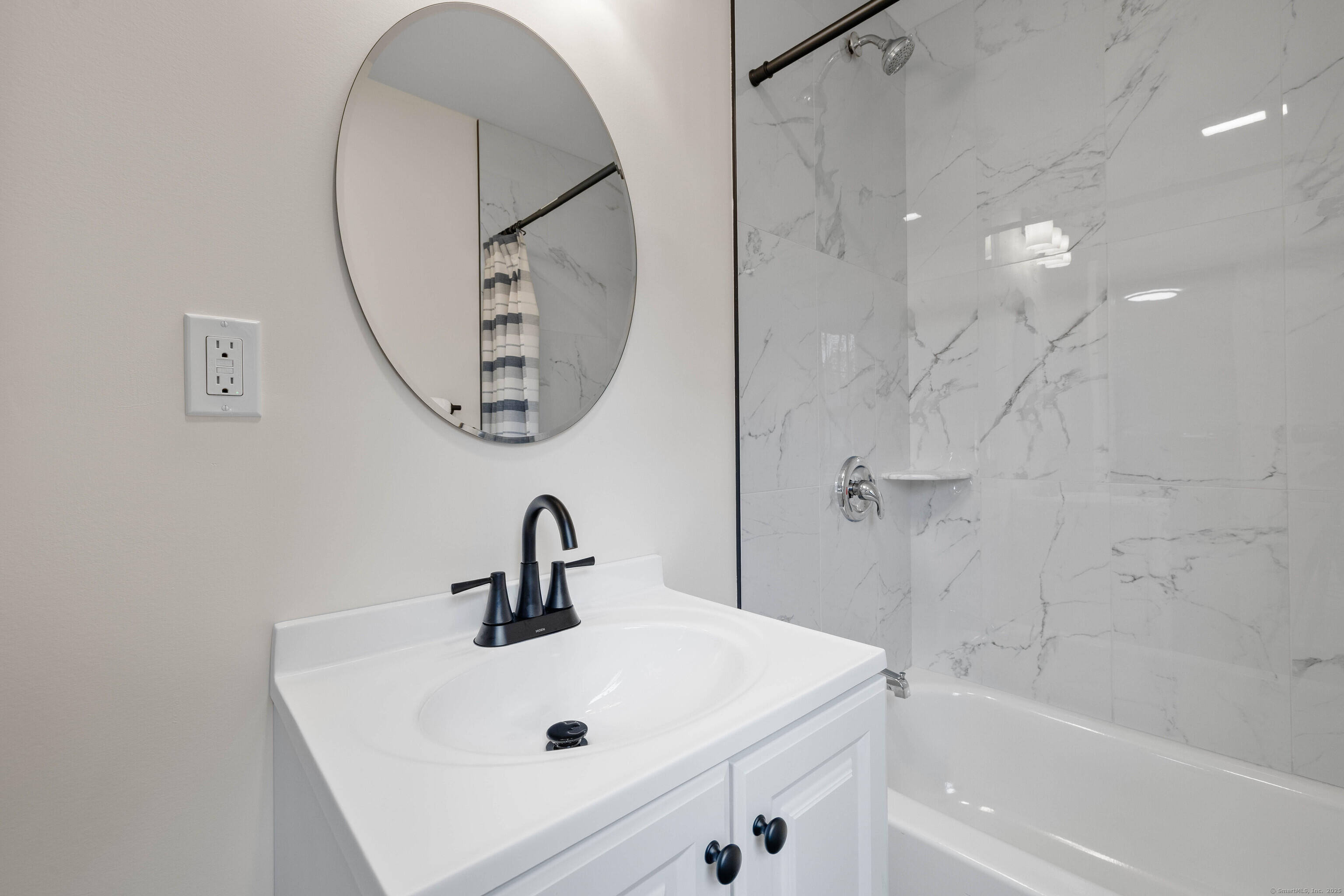 82 State Street Guilford, CT 06437 - Photo 27 of 40 a bathroom with a sink a mirror and a bathtub