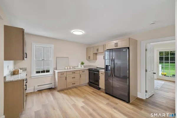 a kitchen with a refrigerator stove and sink