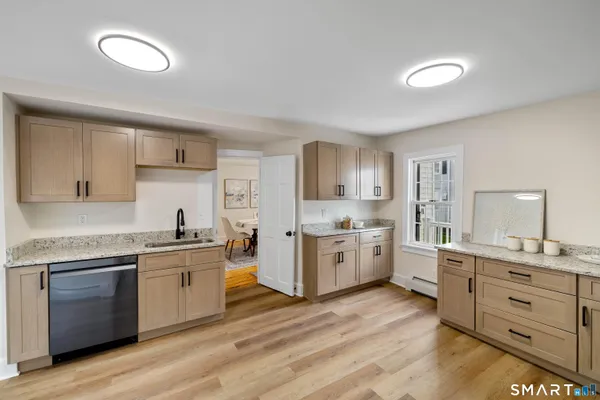 a large kitchen with cabinets a sink and appliances