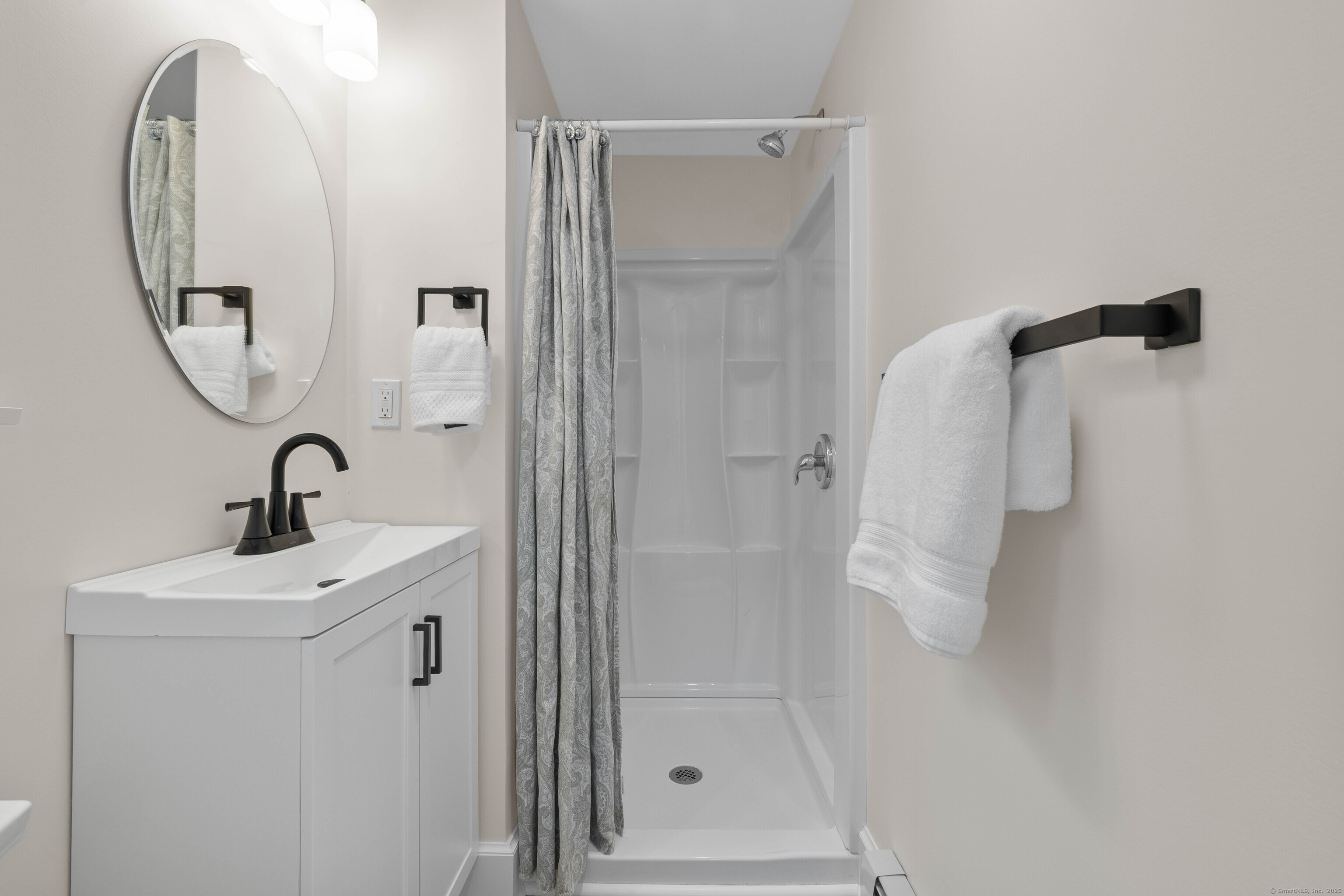 82 State Street Guilford, CT 06437 - Photo 10 of 40 a bathroom with a sink and mirror