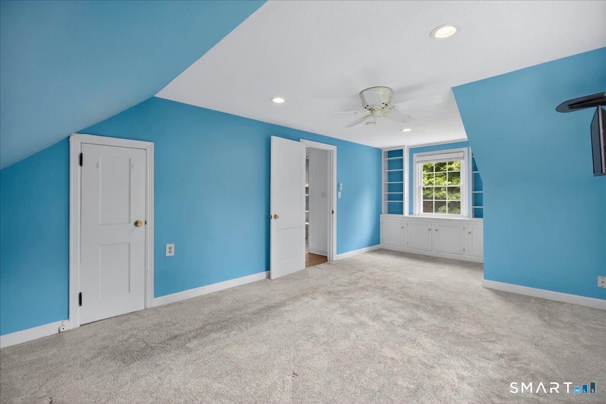 1006 King Road Cheshire, CT 06410 - Photo 17 of 40 Bright and spacious, this Bedroom boasts built-ins and a shared walk-in closet.