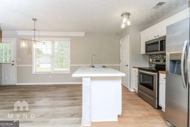 a kitchen with a sink stove and microwave