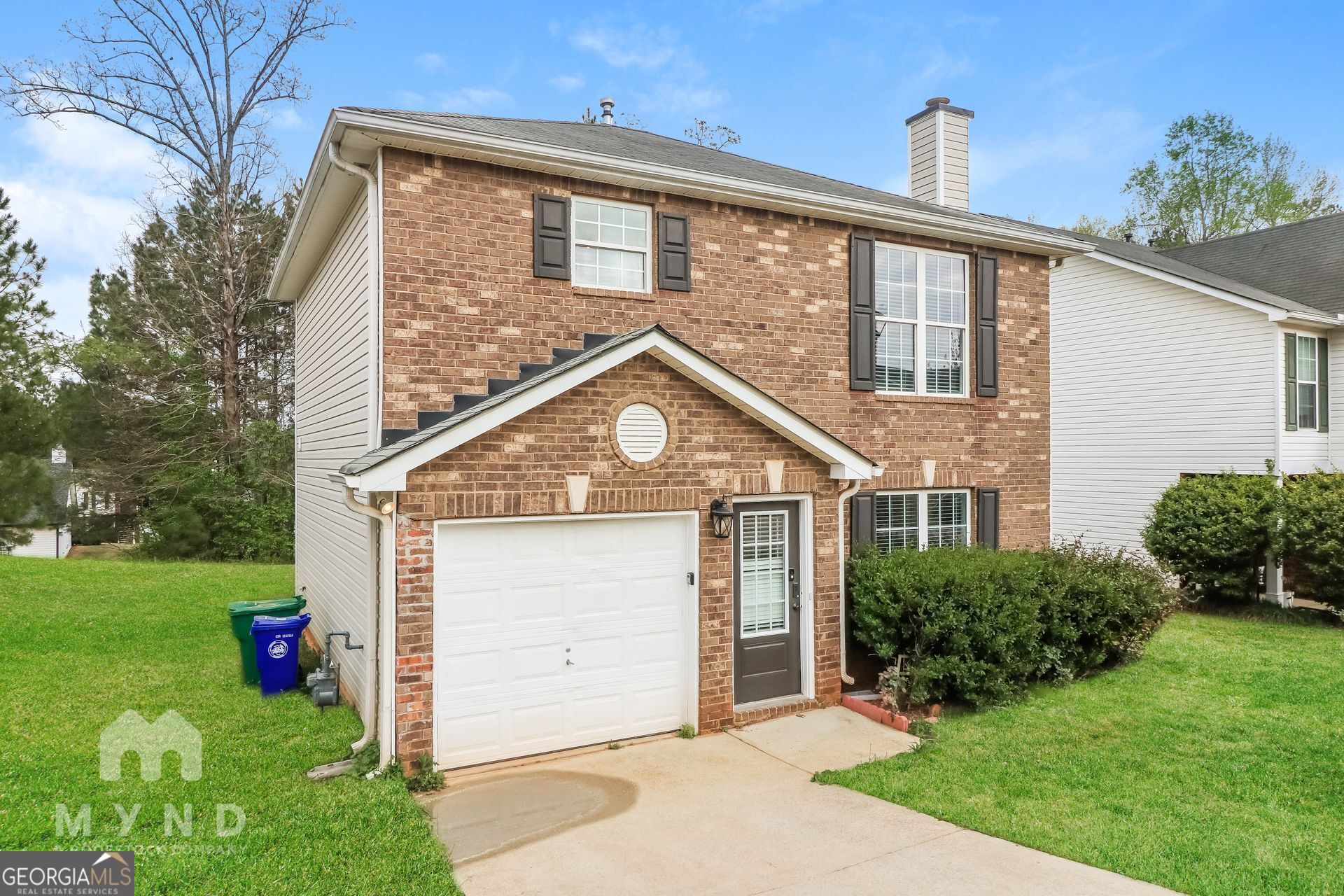3828 Leyland Drive Decatur, GA 30034 - Photo 21 of 26 a front view of a house with a yard and garage