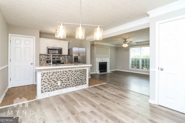 a view of kitchen with sink microwave and refrigerator
