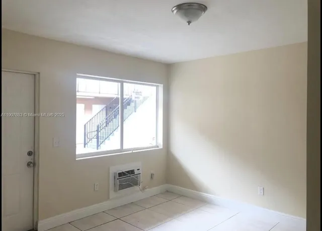 a view of an empty room with a window