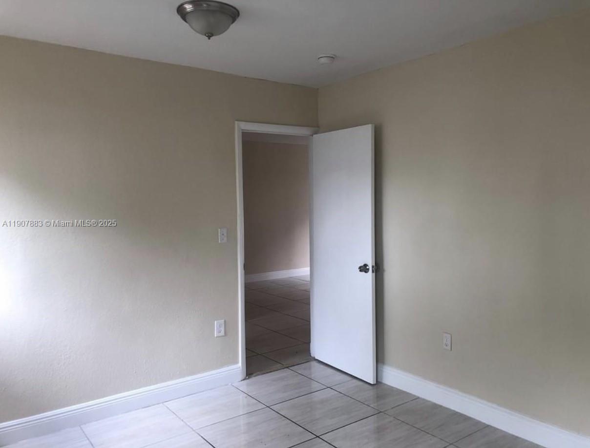 1940 Washington Avenue, Unit 15 Opa-Locka, FL 33054 - Photo 10 of 17 an empty room with an entryway