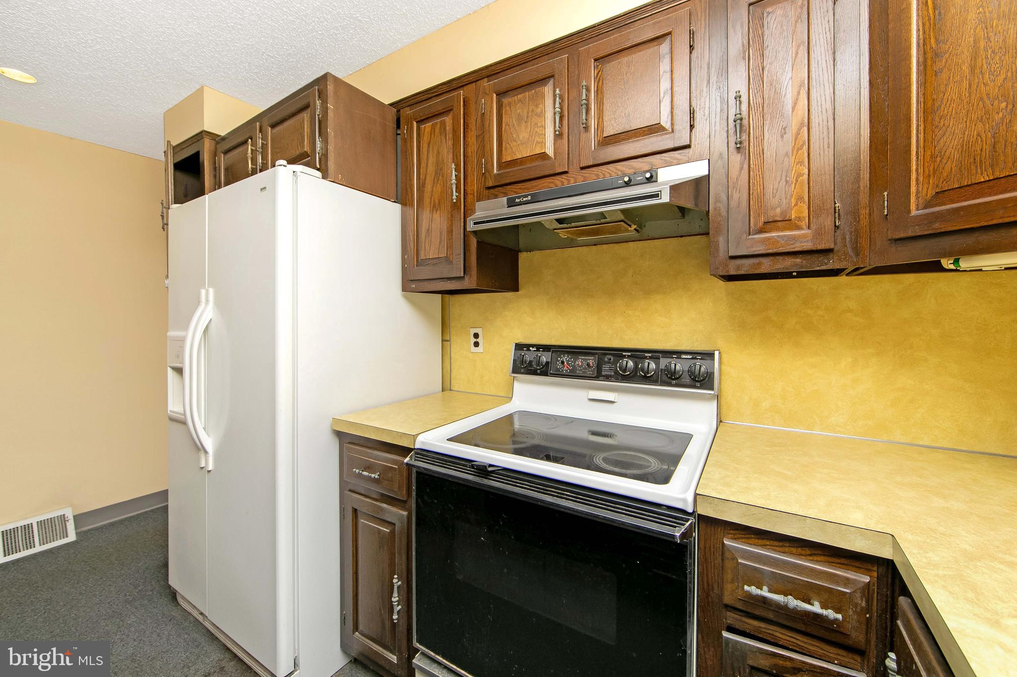 681 Dutton Circle Springfield, PA 19064 - Photo 14 of 45 a kitchen with a stove cabinets and a refrigerator