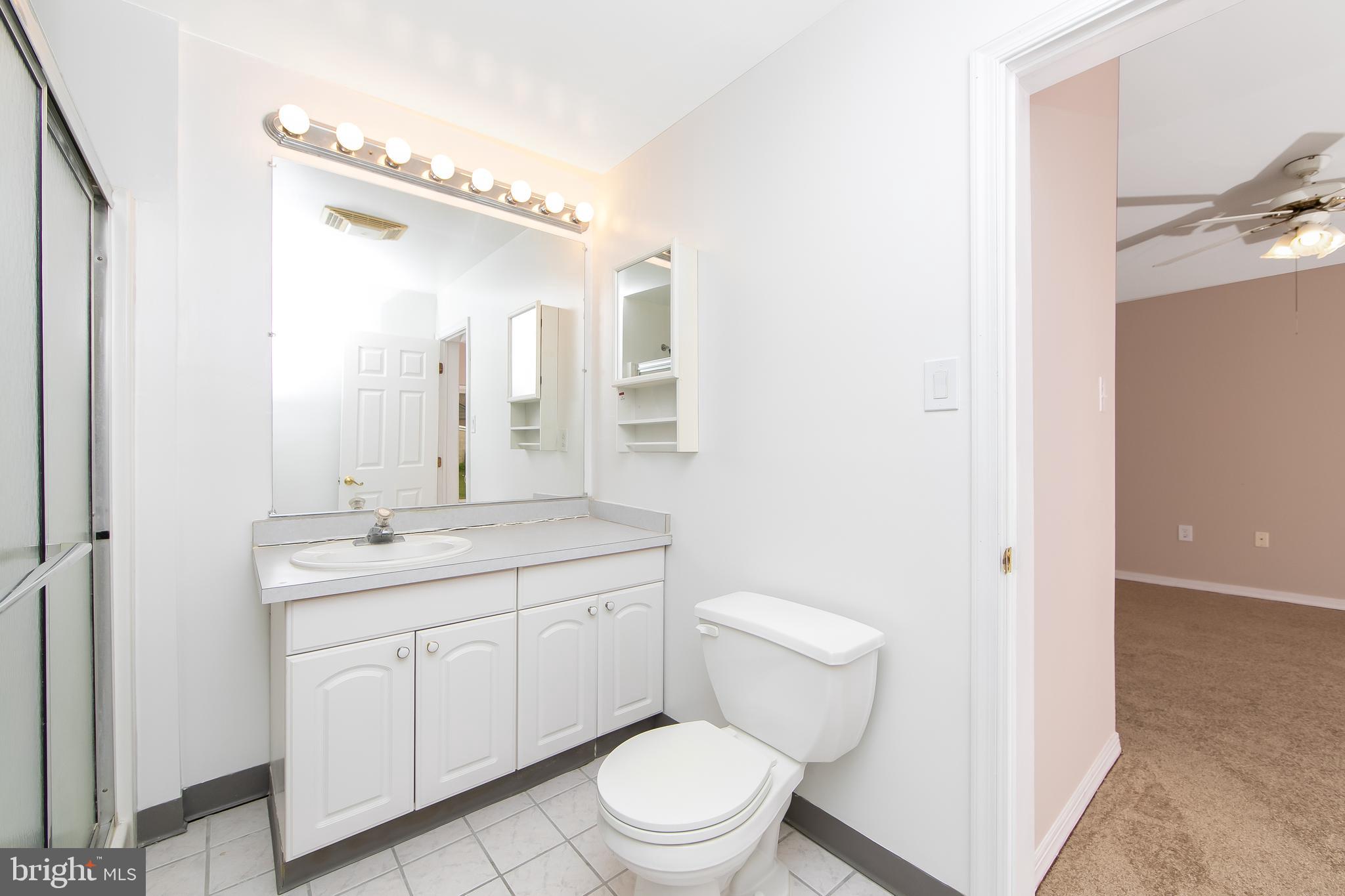 681 Dutton Circle Springfield, PA 19064 - Photo 23 of 45 a bathroom with a toilet a sink and a mirror