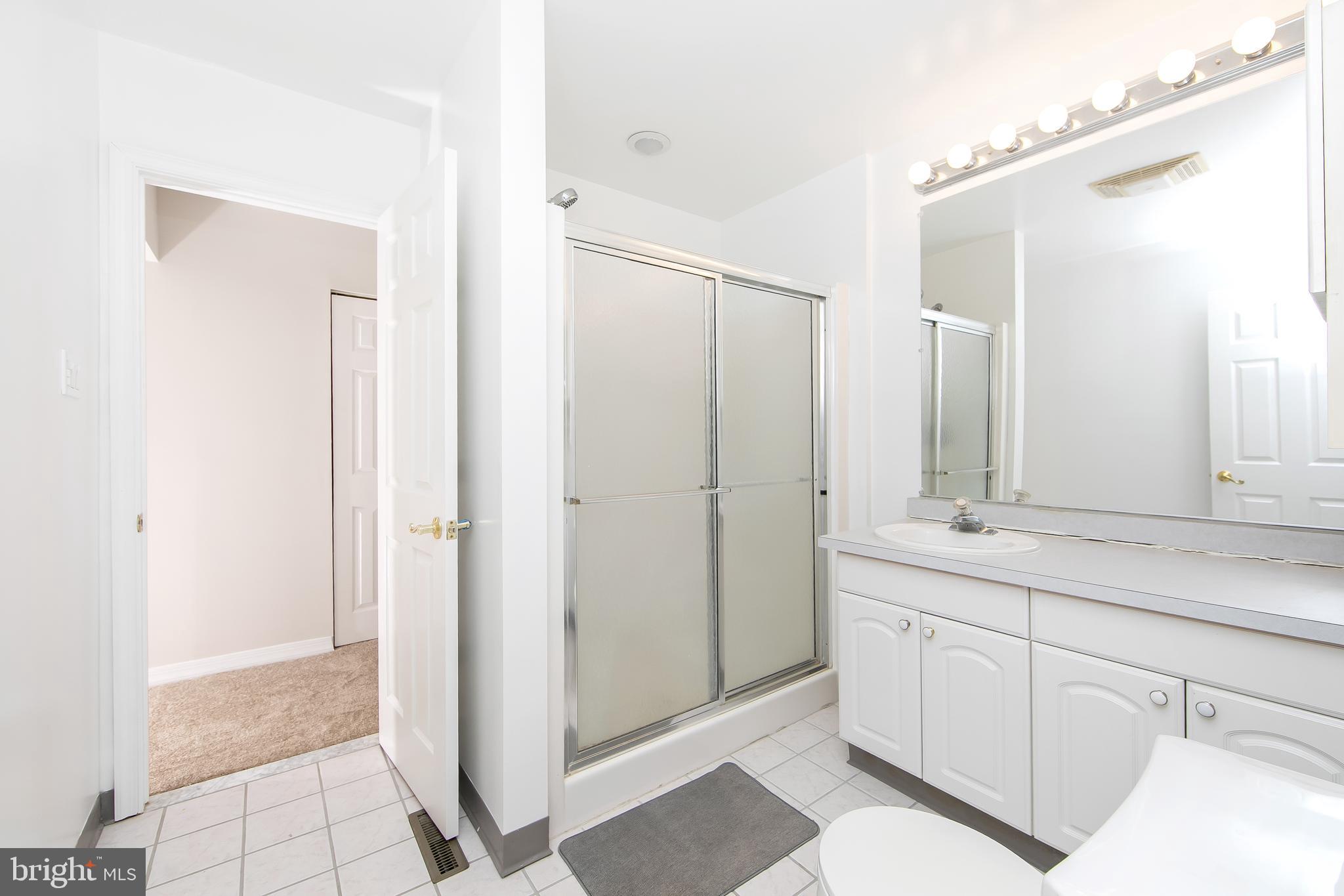 681 Dutton Circle Springfield, PA 19064 - Photo 24 of 45 a bathroom with a double vanity sink a mirror and a shower