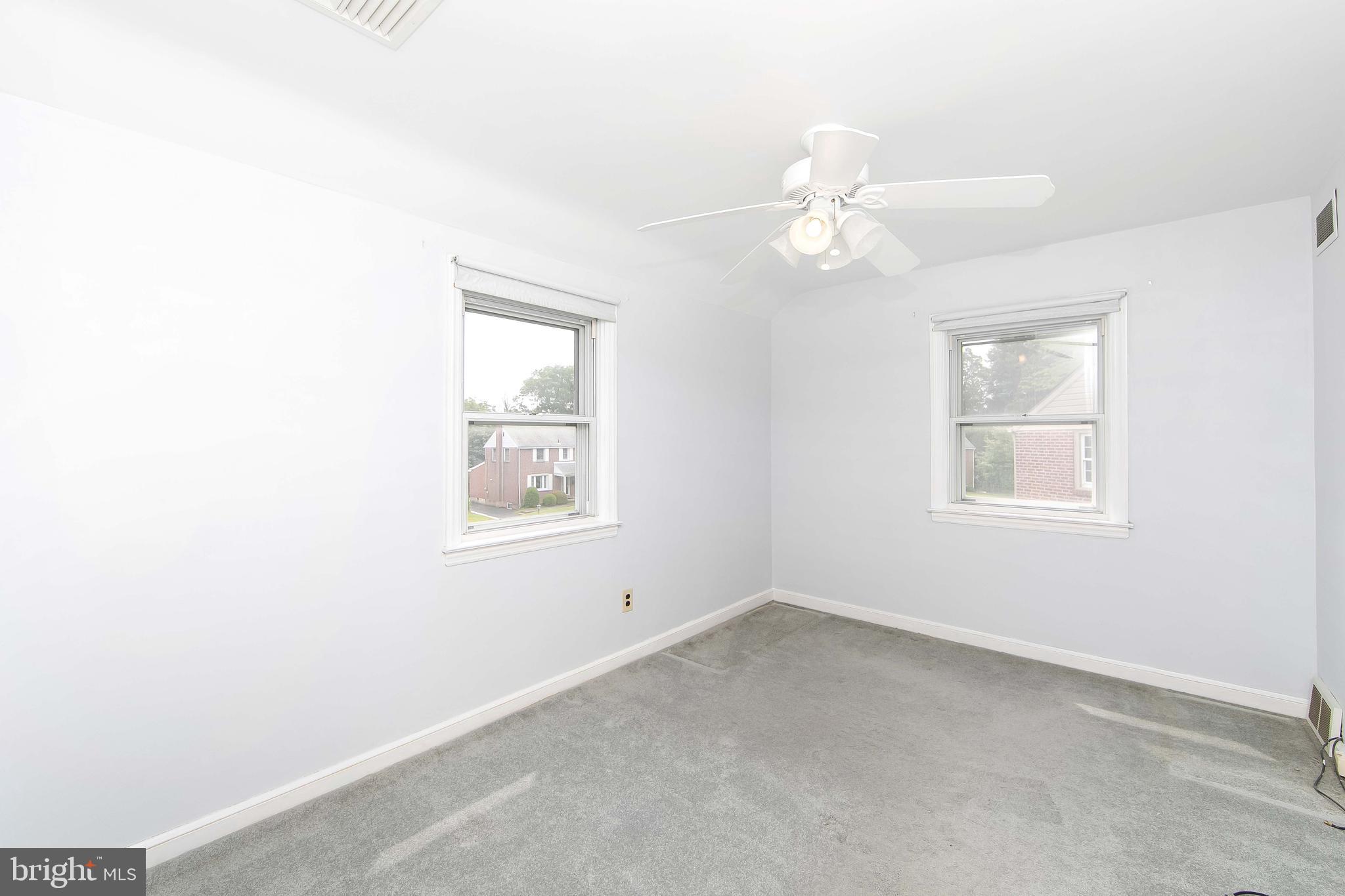 681 Dutton Circle Springfield, PA 19064 - Photo 27 of 45 an empty room with a window and a fan
