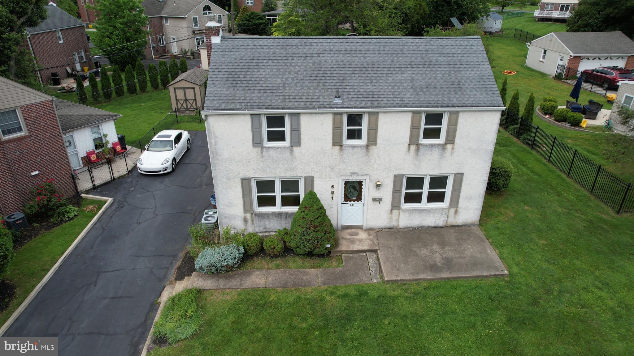 681 Dutton Circle Springfield, PA 19064 - Photo 3 of 45 a aerial view of a house next to a big yard and large trees