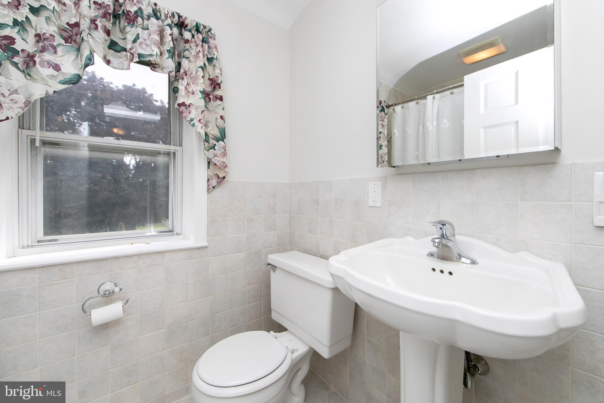 681 Dutton Circle Springfield, PA 19064 - Photo 31 of 45 a bathroom with a sink a toilet and a mirror