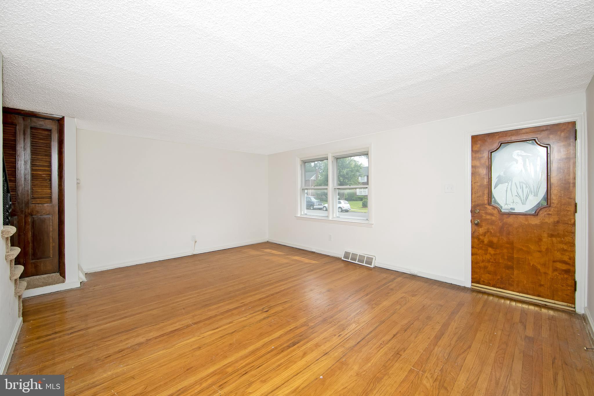 681 Dutton Circle Springfield, PA 19064 - Photo 7 of 45 an empty room with wooden floor and windows