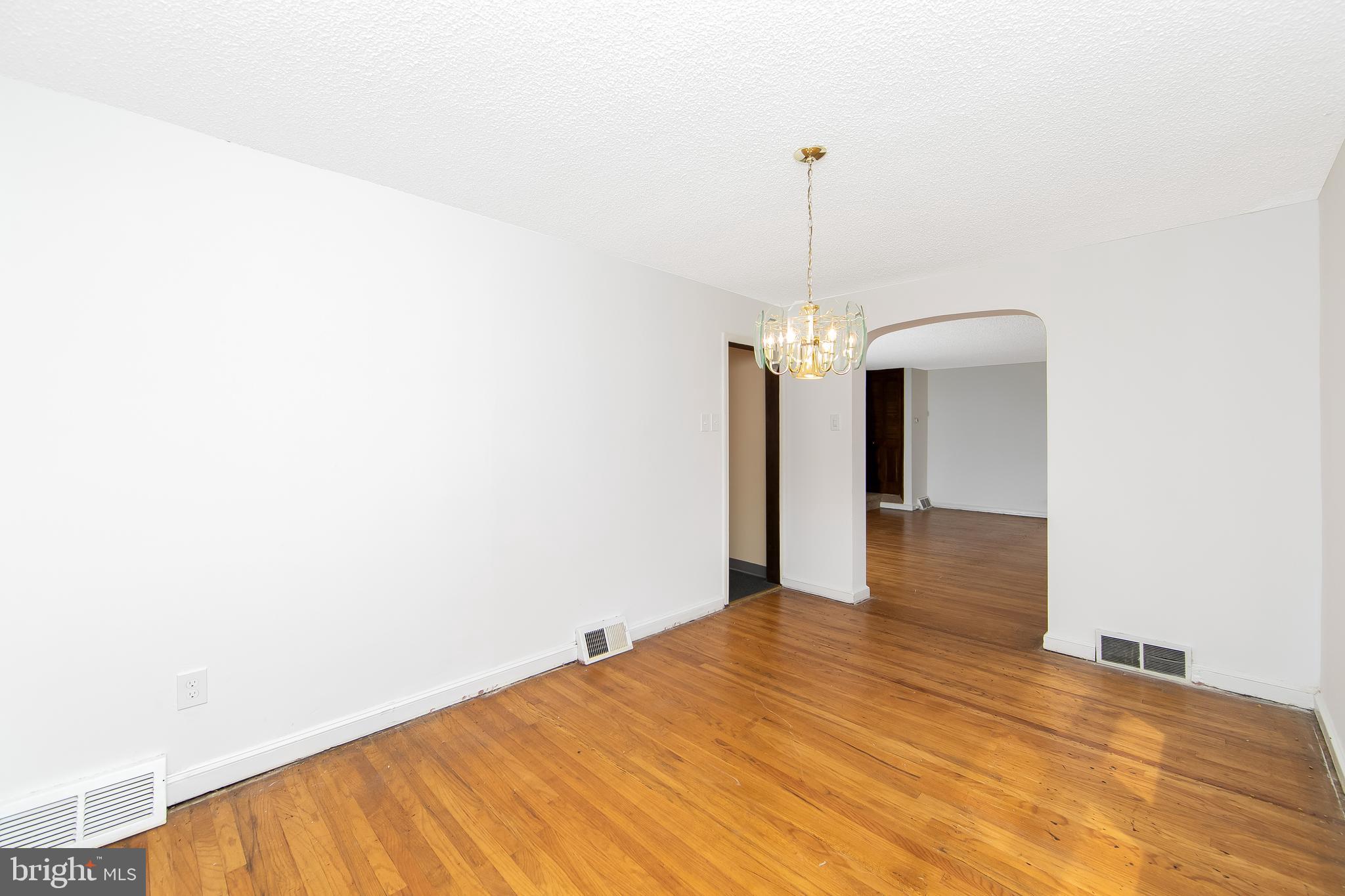 681 Dutton Circle Springfield, PA 19064 - Photo 10 of 45 a bedroom with a bed and a chandelier