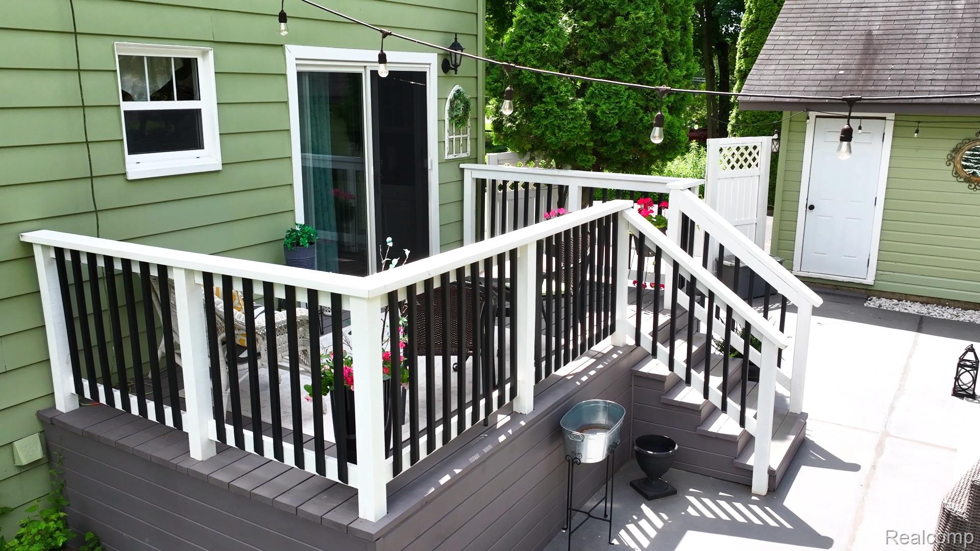 3841 Covert Road Waterford, MI 48328 - Photo 79 of 87 Private deck with multi-level composite decking, white and black railing, and sliding glass door access