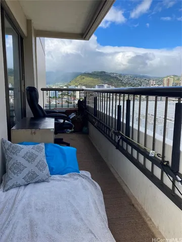 a balcony with furniture and a city view