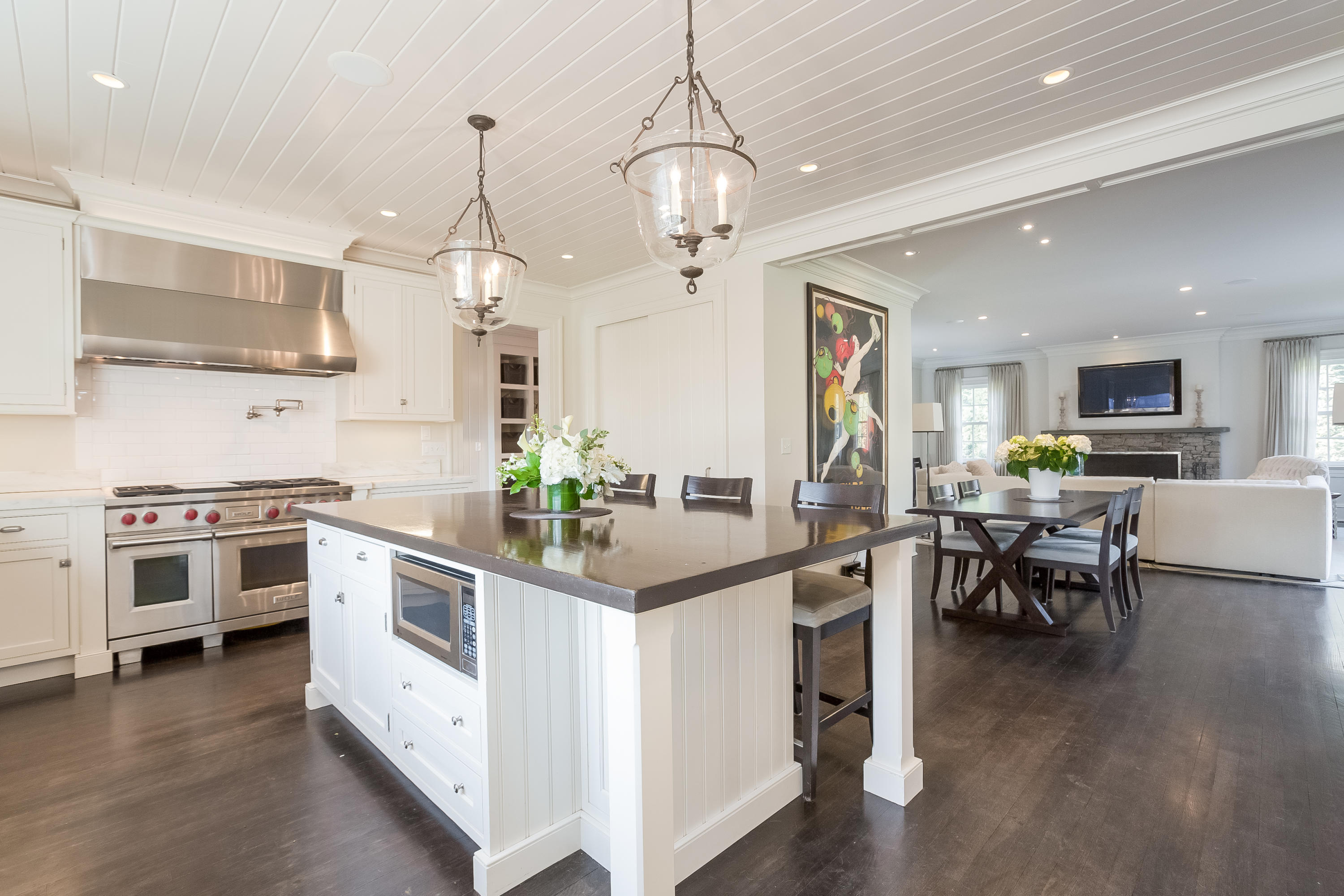 6 Davis Lane Darien, CT 06820 - Photo 13 of 49 a kitchen with stove a sink dishwasher white refrigerator a dining table and chairs with wooden floor