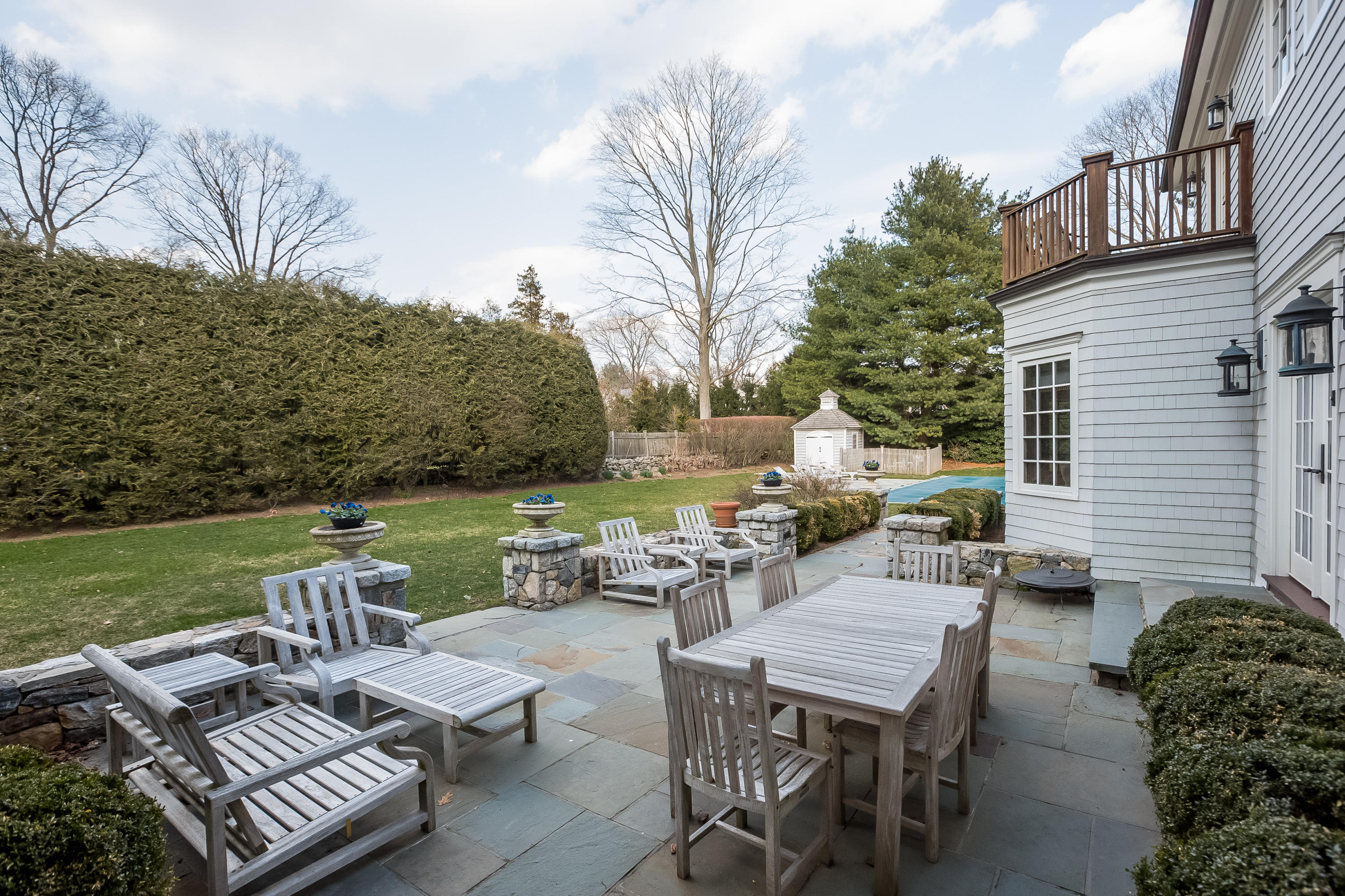 6 Davis Lane Darien, CT 06820 - Photo 39 of 49 a view of a patio with table and chairs and potted plants with sky view