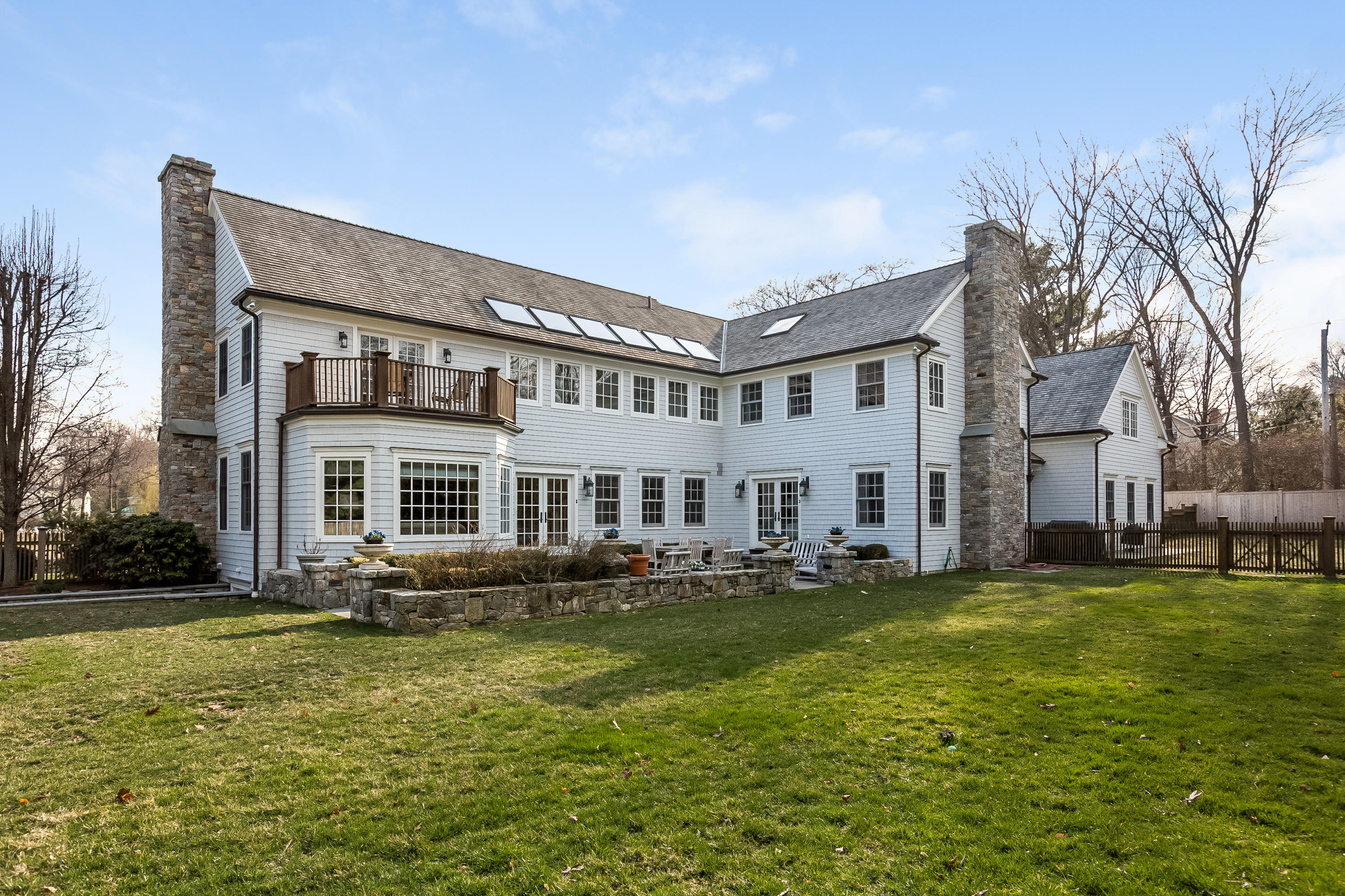 6 Davis Lane Darien, CT 06820 - Photo 41 of 49 a front view of a house with a garden and trees