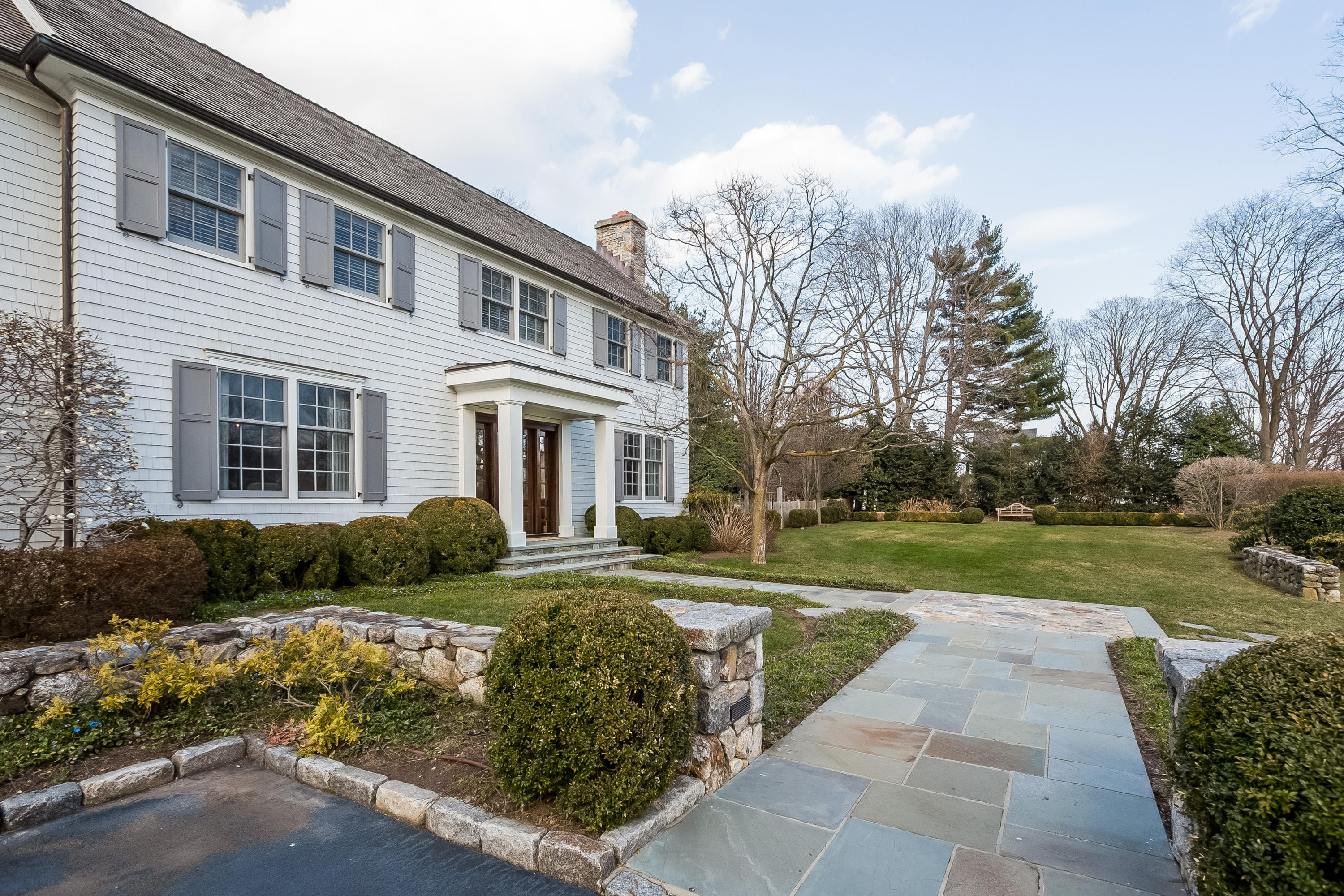 6 Davis Lane Darien, CT 06820 - Photo 43 of 49 a front view of a house with garden and trees