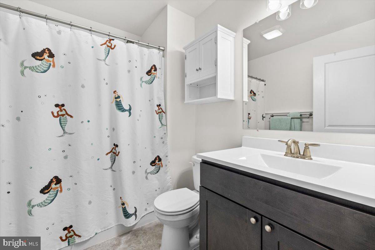 106 Split Rail Road Front Royal, VA 22630 - Photo 18 of 35 a bathroom with a sink a toilet a shower curtain and a bath tub