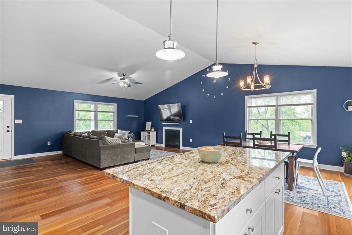 106 Split Rail Road Front Royal, VA 22630 - Photo 4 of 35 a large kitchen with kitchen island a stove a counter top a dining table and chairs
