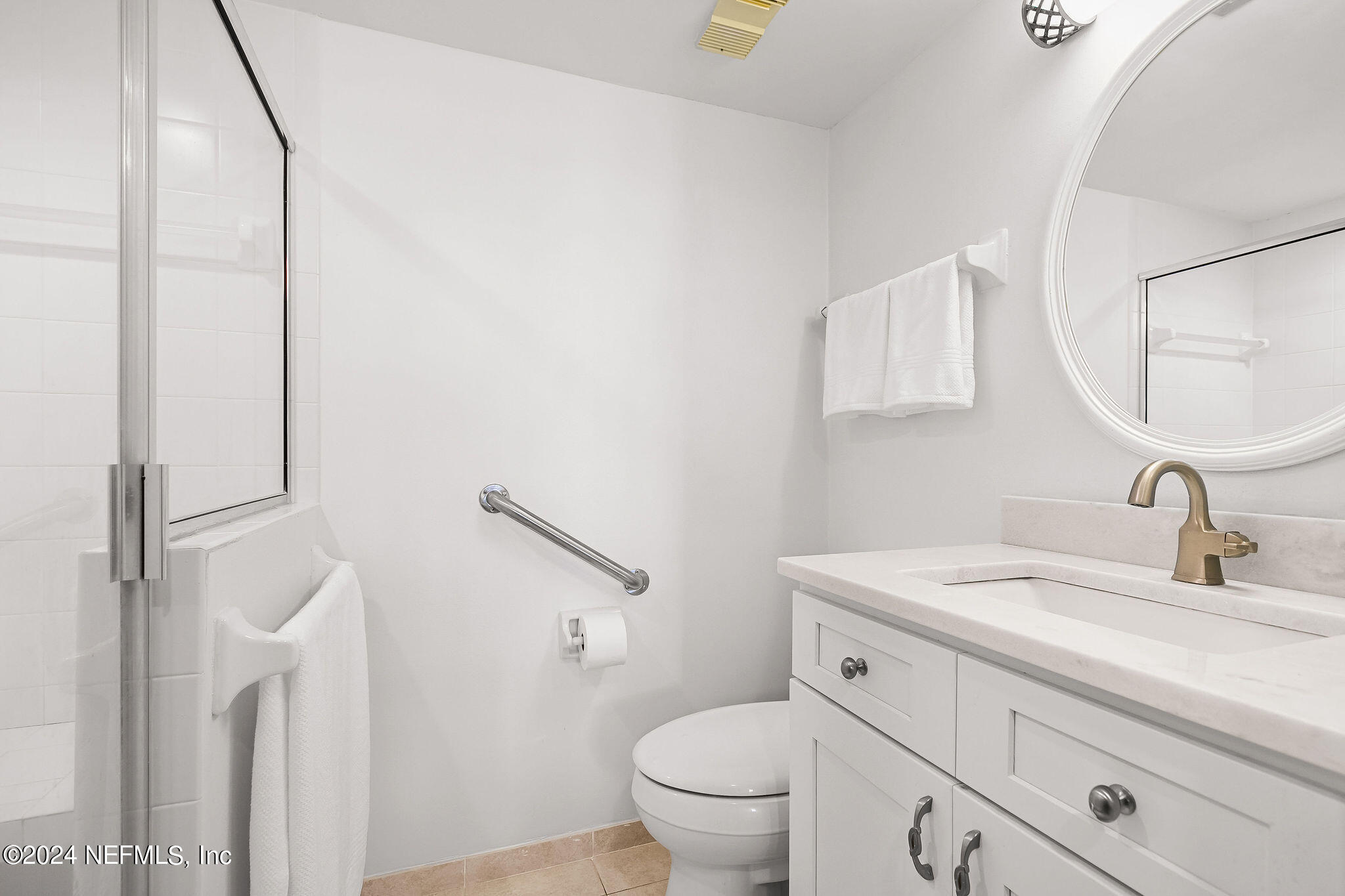 390 A1A Beach Boulevard, Unit 50 St. Augustine, FL 32080 - Photo 11 of 20 a bathroom with a toilet sink and mirror