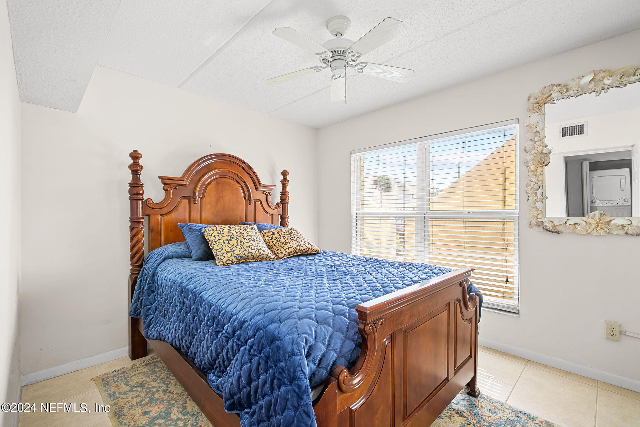 390 A1A Beach Boulevard, Unit 50 St. Augustine, FL 32080 - Photo 12 of 20 a bedroom with a bed and a window