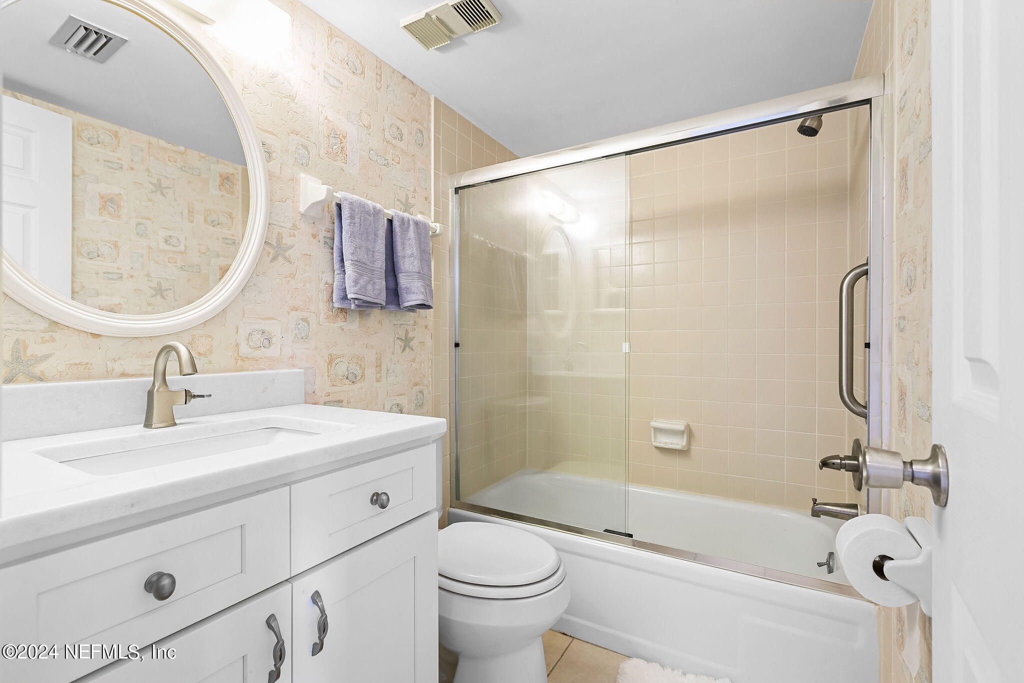 390 A1A Beach Boulevard, Unit 50 St. Augustine, FL 32080 - Photo 13 of 20 a bathroom with a sink a toilet and a mirror