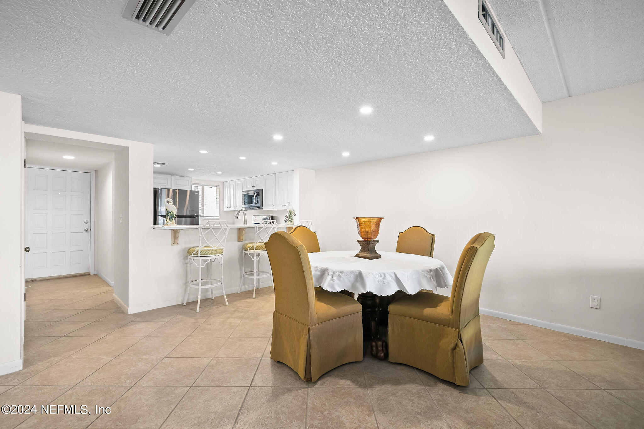 390 A1A Beach Boulevard, Unit 50 St. Augustine, FL 32080 - Photo 7 of 20 a living room with furniture and kitchen view
