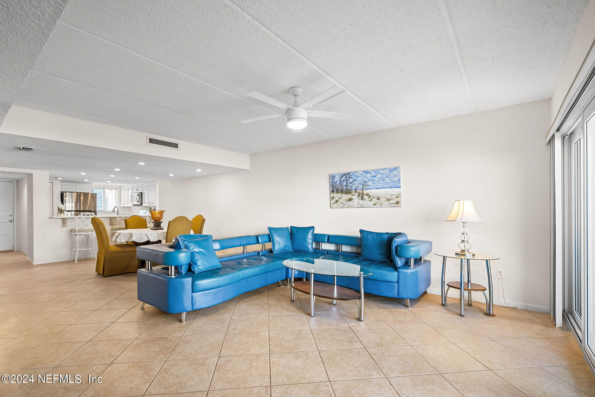 390 A1A Beach Boulevard, Unit 50 St. Augustine, FL 32080 - Photo 8 of 20 a living room with furniture and a chandelier