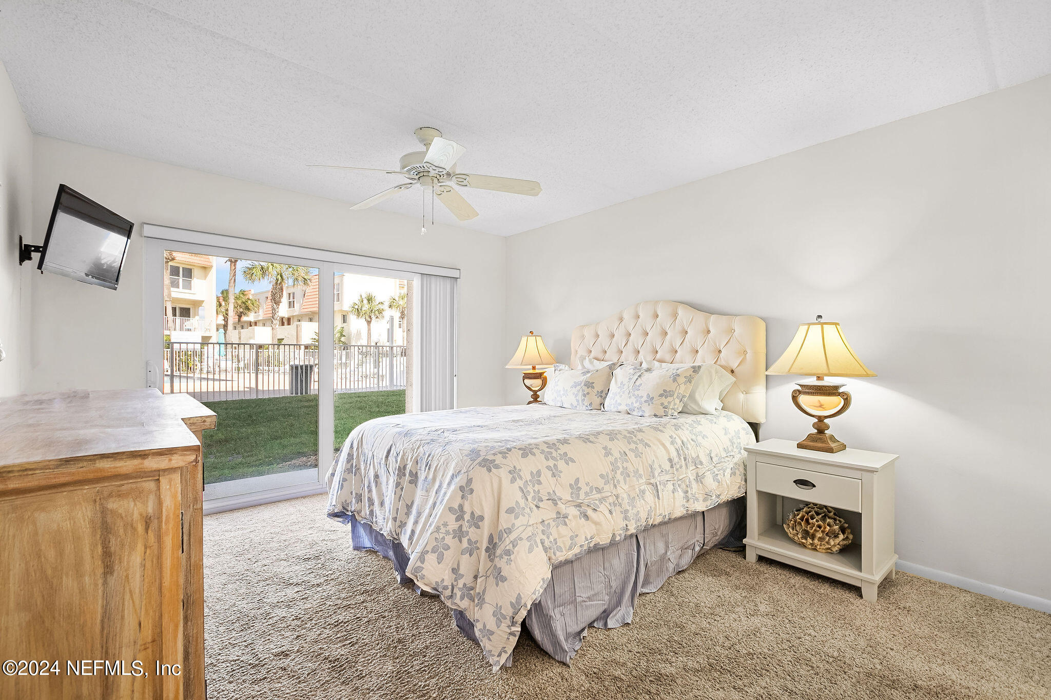 390 A1A Beach Boulevard, Unit 50 St. Augustine, FL 32080 - Photo 9 of 20 a bedroom with a bed a stove and a window