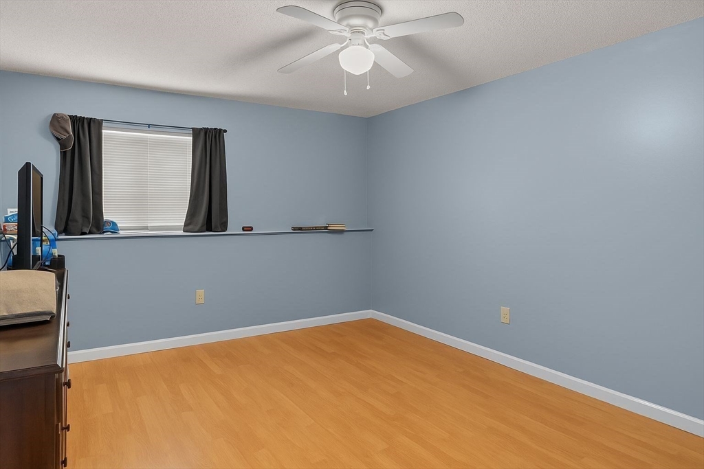 5455 North Main Street, Unit 14B Fall River, MA 02720 - Photo 4 of 8 an empty room with a chandelier fan and windows