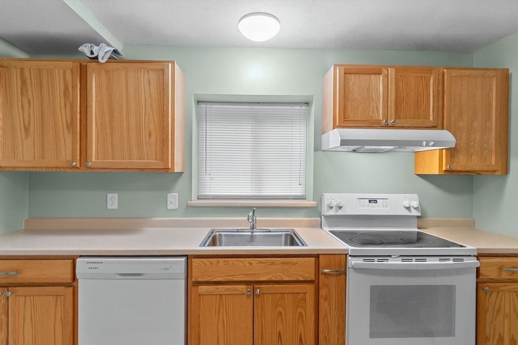 5455 North Main Street, Unit 14B Fall River, MA 02720 - Photo 6 of 8 a kitchen with granite countertop a sink a stove and cabinets
