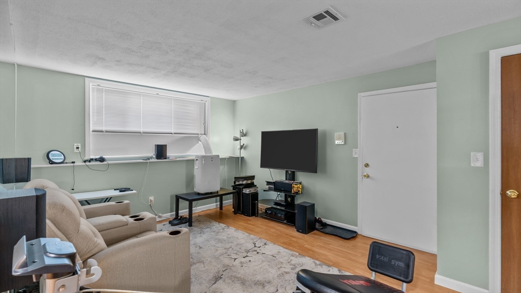 5455 North Main Street, Unit 14B Fall River, MA 02720 - Photo 7 of 8 a room with furniture and a flat screen tv