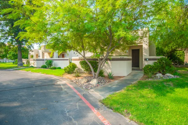 a view of a house with a yard and tree s