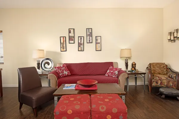 a living room with furniture and a wooden floor